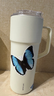 Blue butterfly PVC sticker applied to a cream-colored tumbler