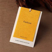 Yellow custom clothing hang tag with string attachment