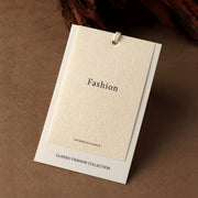 Cream custom clothing hang tag with string attachment